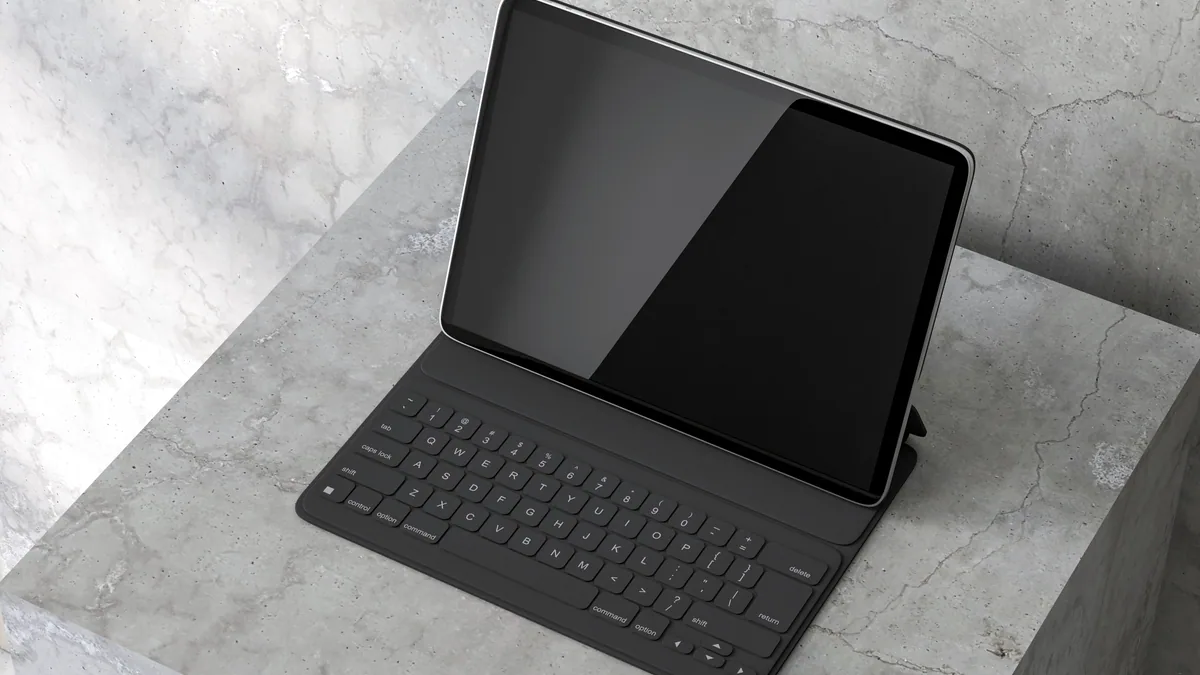 A black tablet with a physical keyboard, half slid out from its rubber sleeve.
